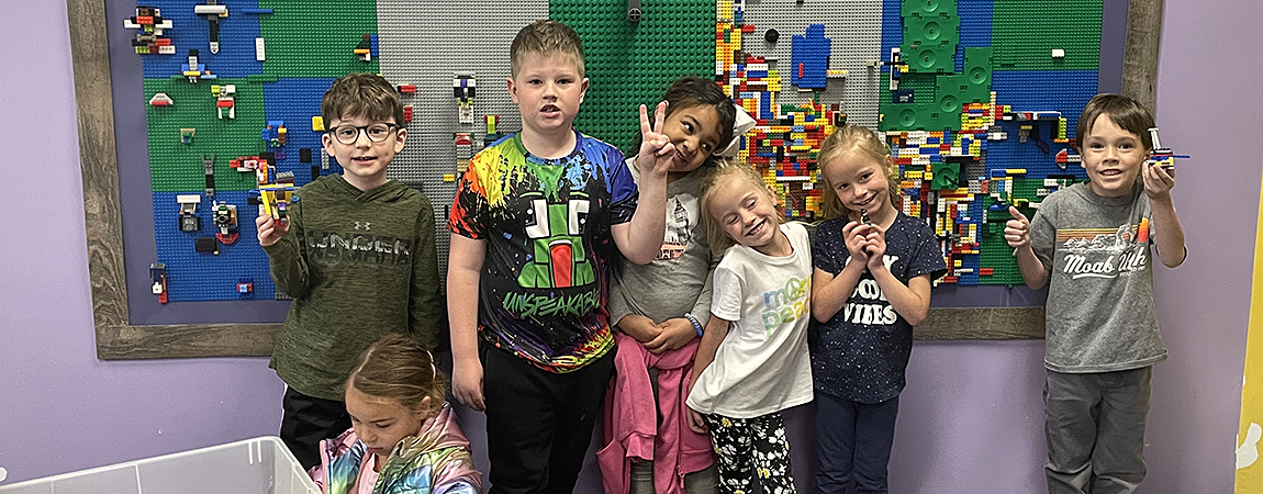 FRCS kindergarten students show off their engineering and building skills in front of the ECE Lego wall
