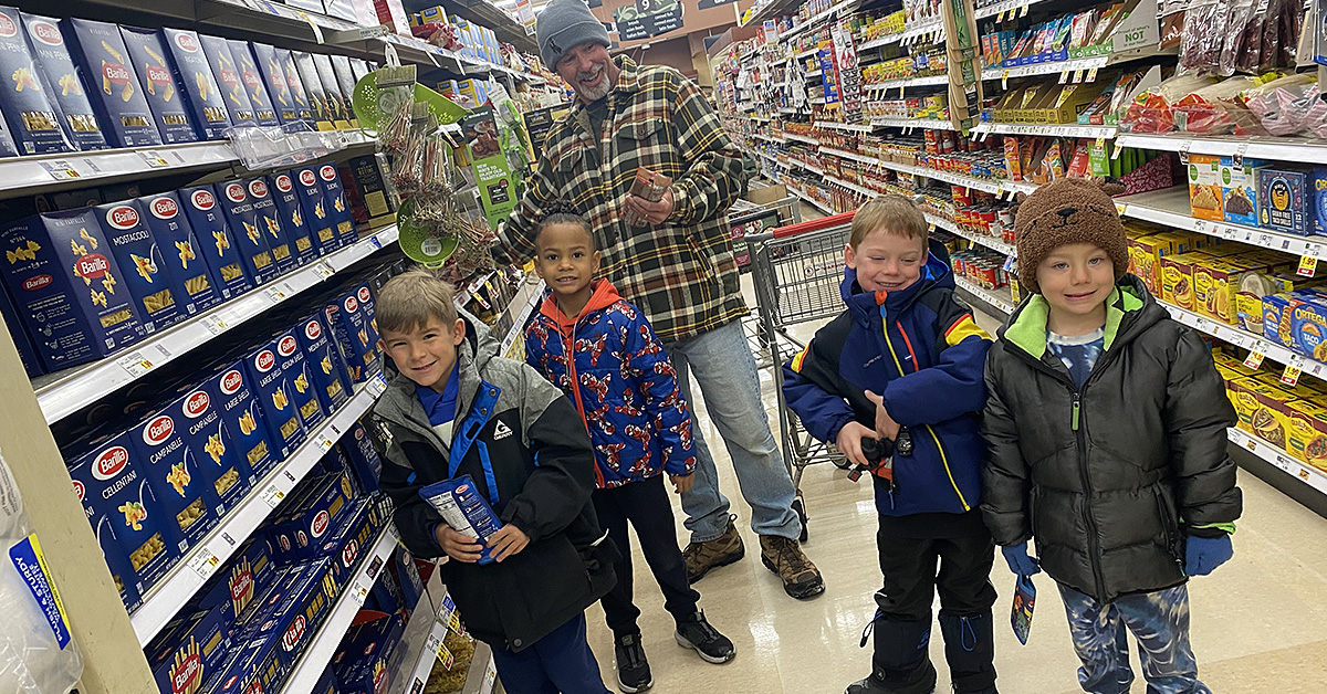 FRCS kindergarten students shop with Mr. Ron for Food Drive goods