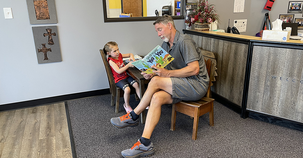 Mr. Ron reading a book to ECE student